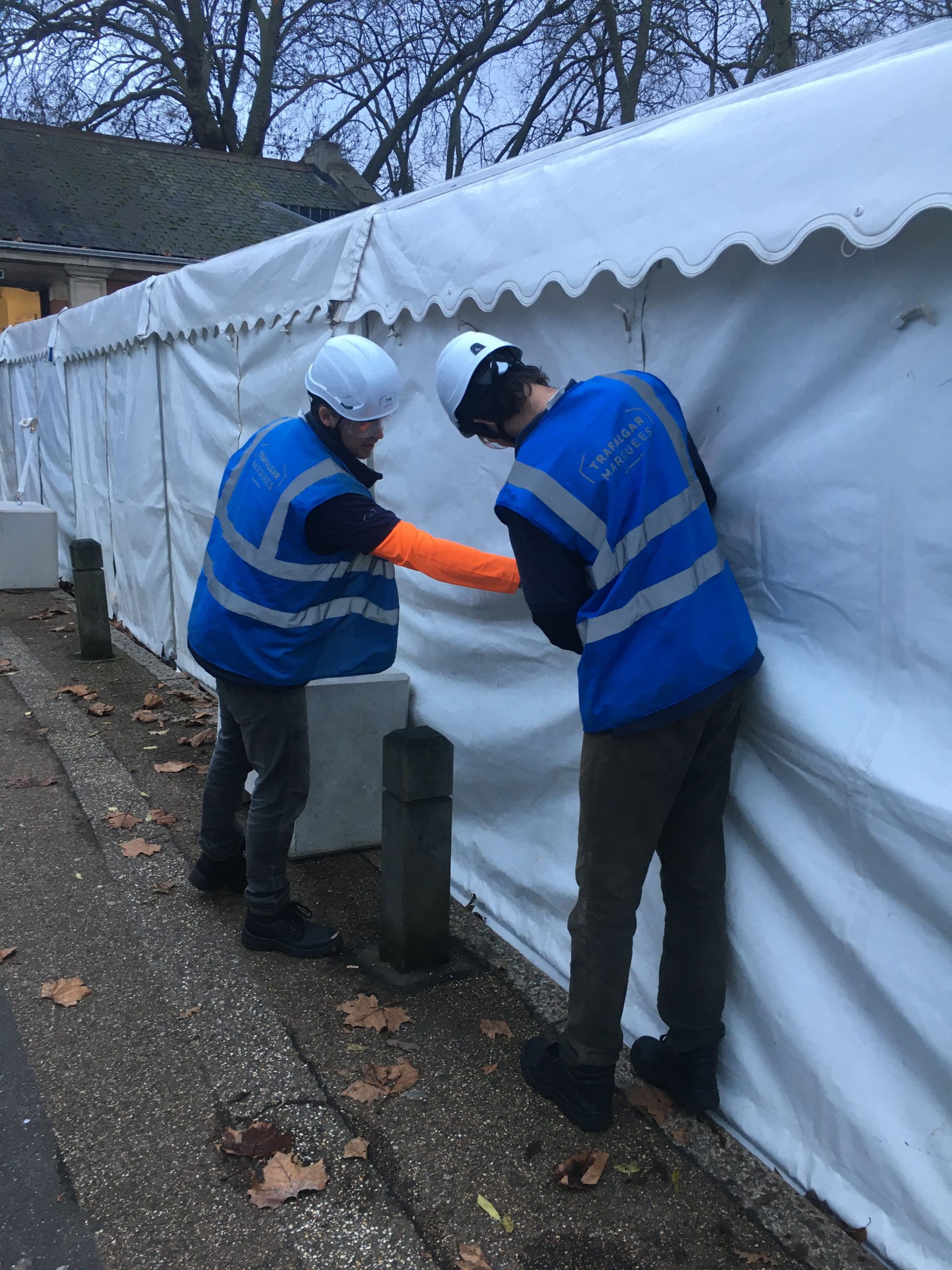 team members checking the safety of a marquee for an article about weatherproofing your construction site