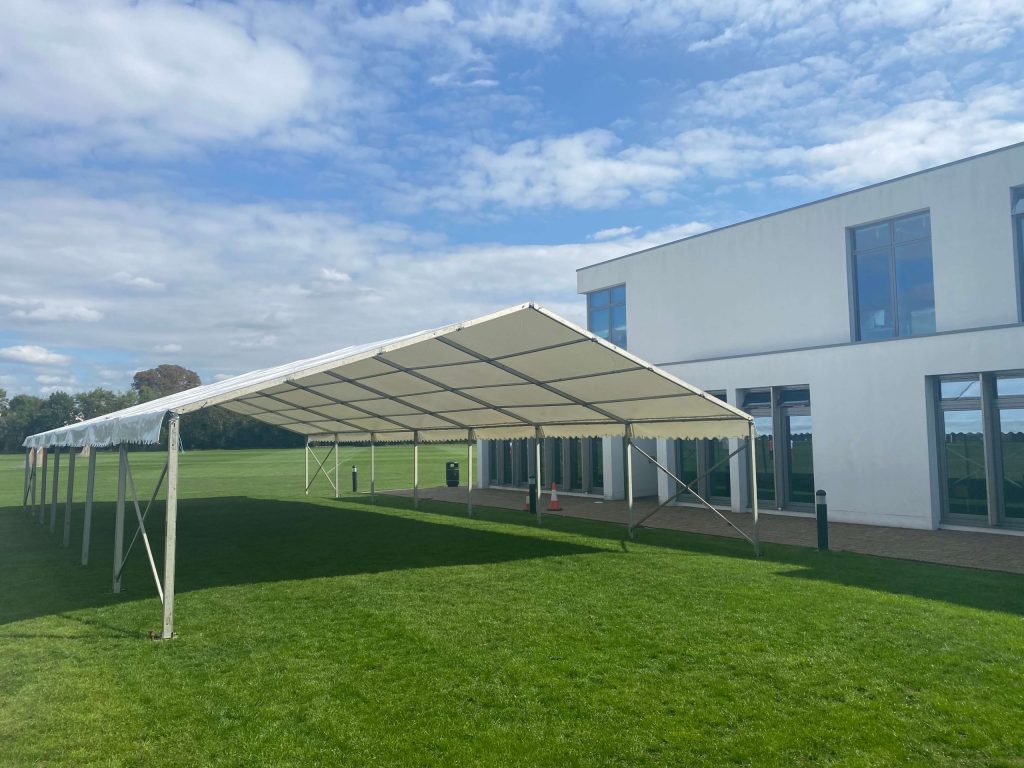 a large out-door marquee used as alternative space for children at a school
