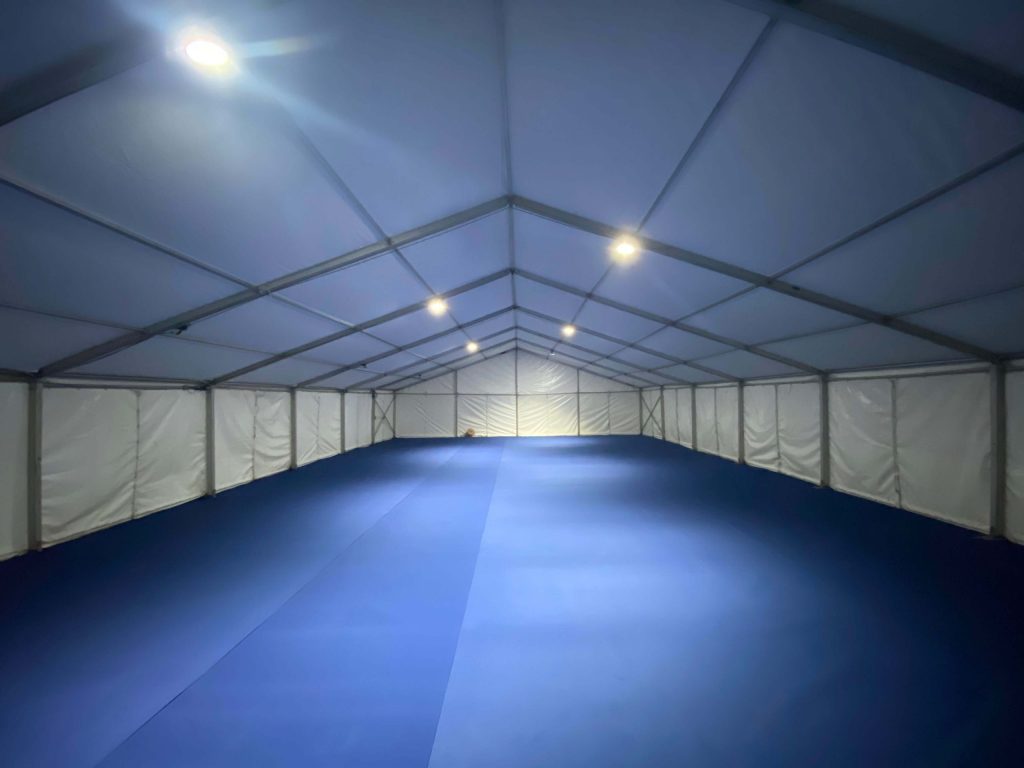 Large (21m x 12m) standard marquee fitted with hard flooring, solid doors and thermostatically controlled heating system for a school