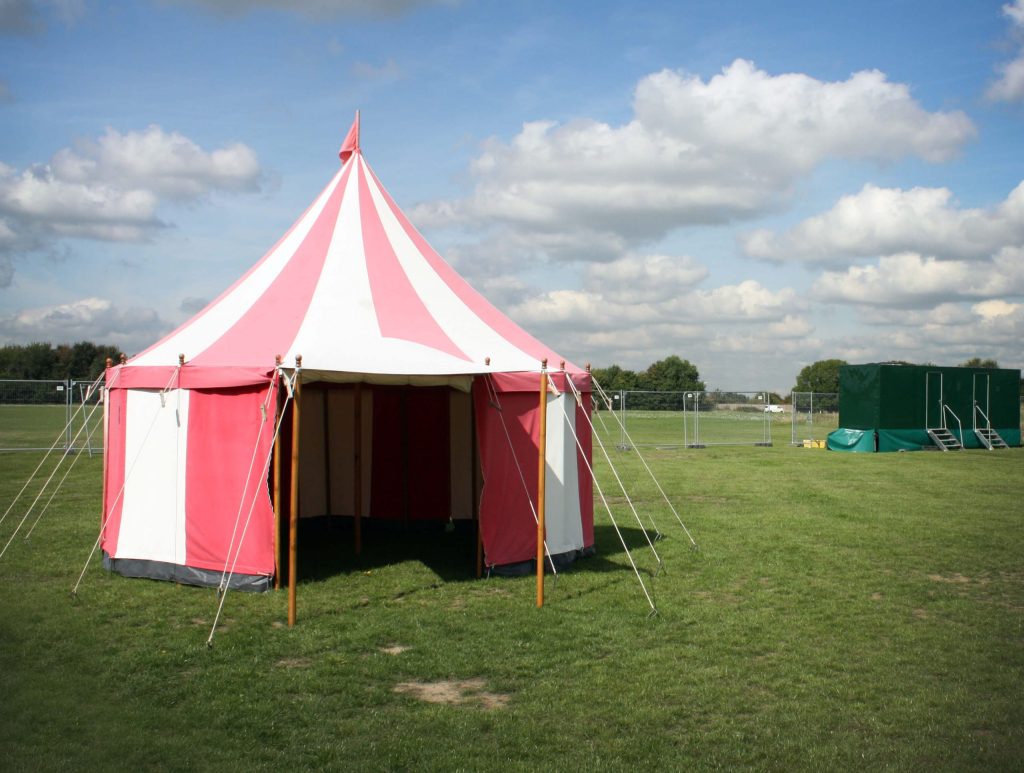 A small red and white stripped marquee used for events