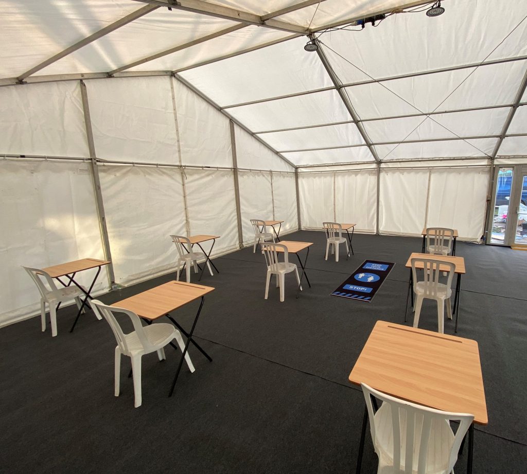 Marquee providing a temporary classroom. Fitted with hard doors to improve security, hard floor, heating and lighting