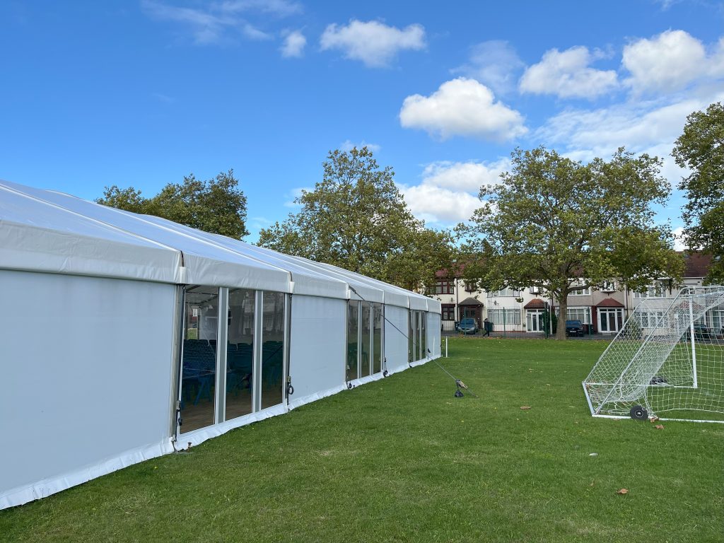 Long term marquee hire London. Exterior view of marquee with solid sides