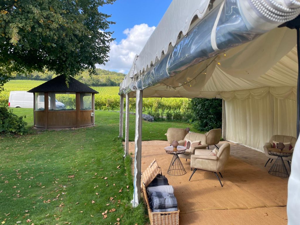 Marquee hire Surrey at Denbies Vineyard Hotel, in Dorking, Surrey. View of marquee with open sides, looking out to the Surrey Hills