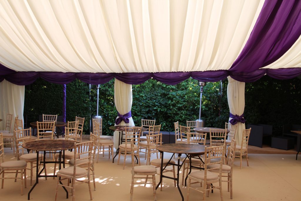 Marquee hire Surrey, marquee with purple swag and roof overlays.